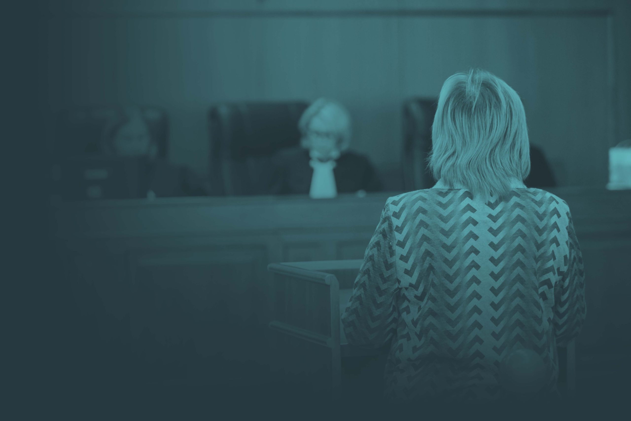 Woman speaking in front of panel of judges