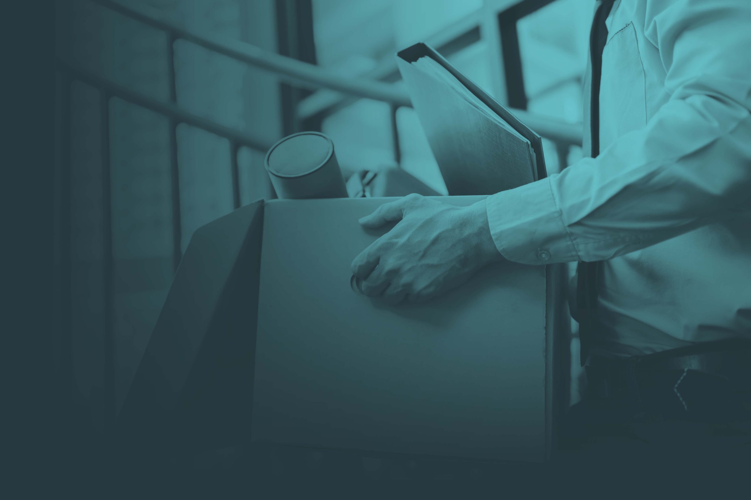 Man carrying box of belongings out of work building