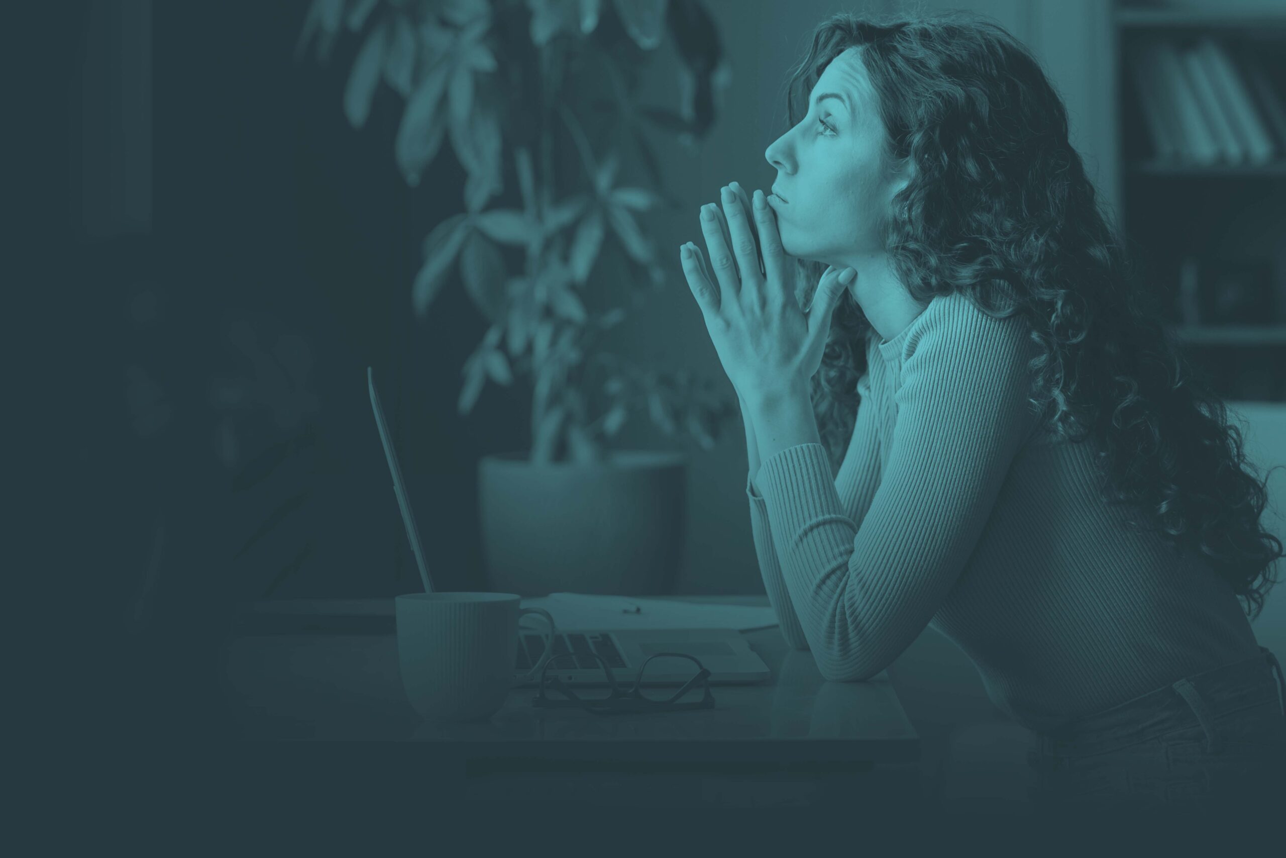 woman thinking in front of laptop