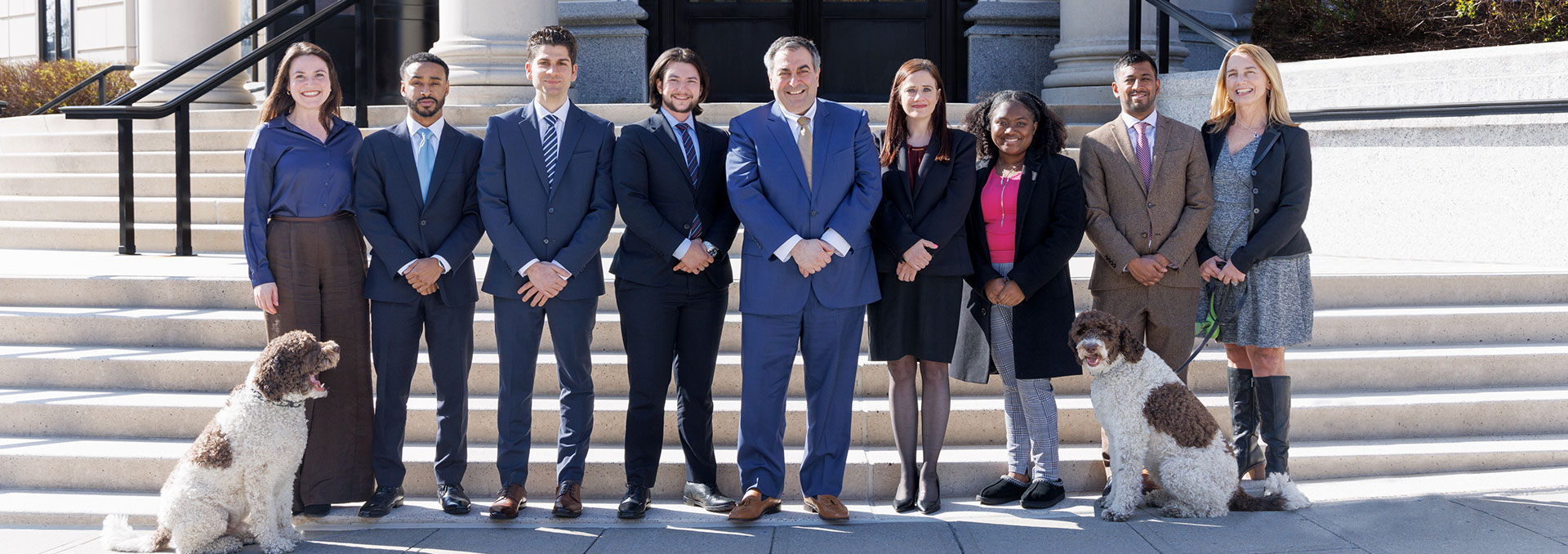 Filippatos Law staff in front of courtroom steps