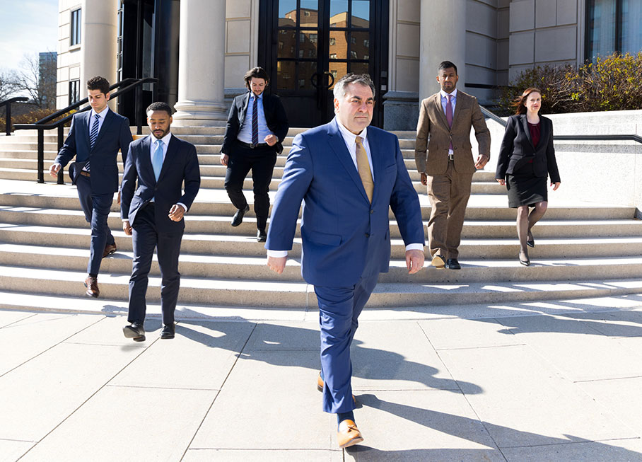 Filippatos team walking down courtroom steps