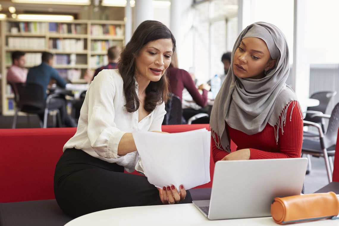 two women looking over paperwork