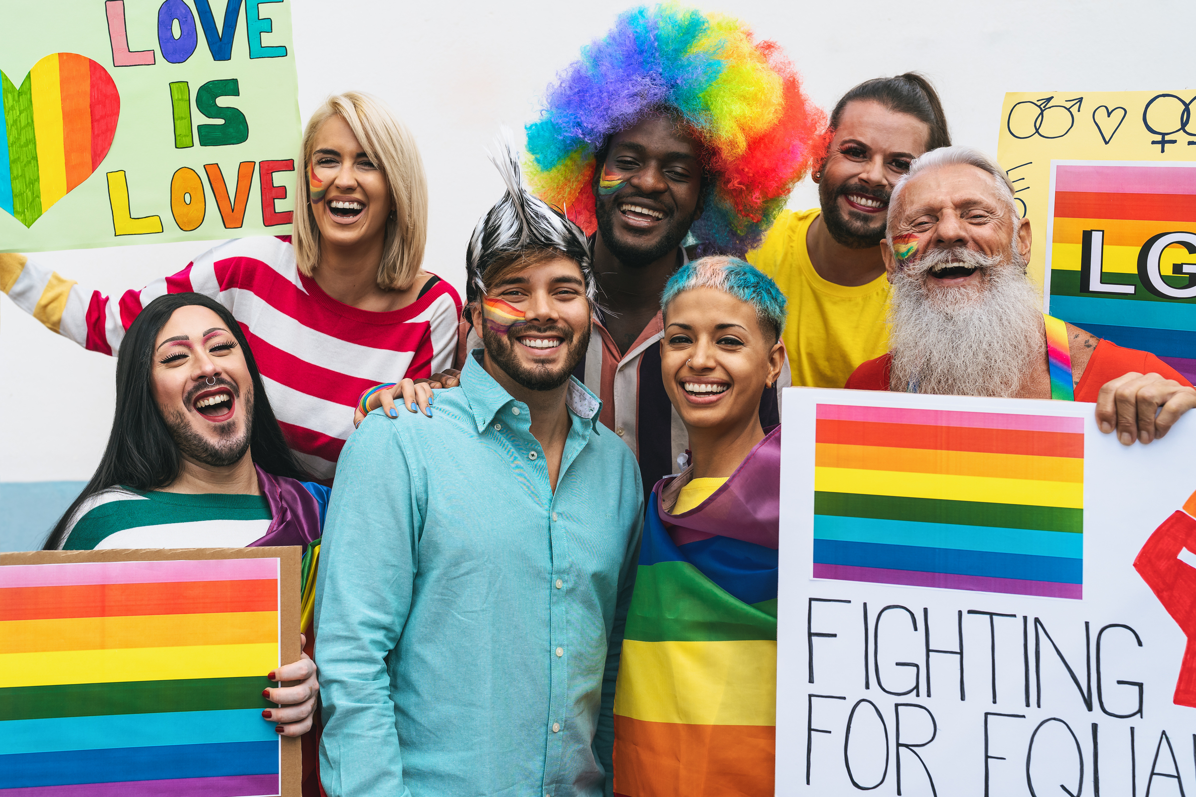 Happy people celebrating at gay pride event outside of their workplace.