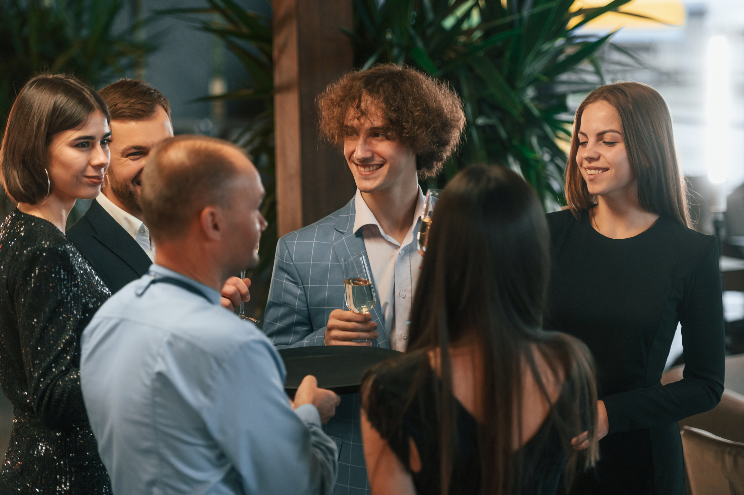 A group of young professionals enjoy an after-hours work event.