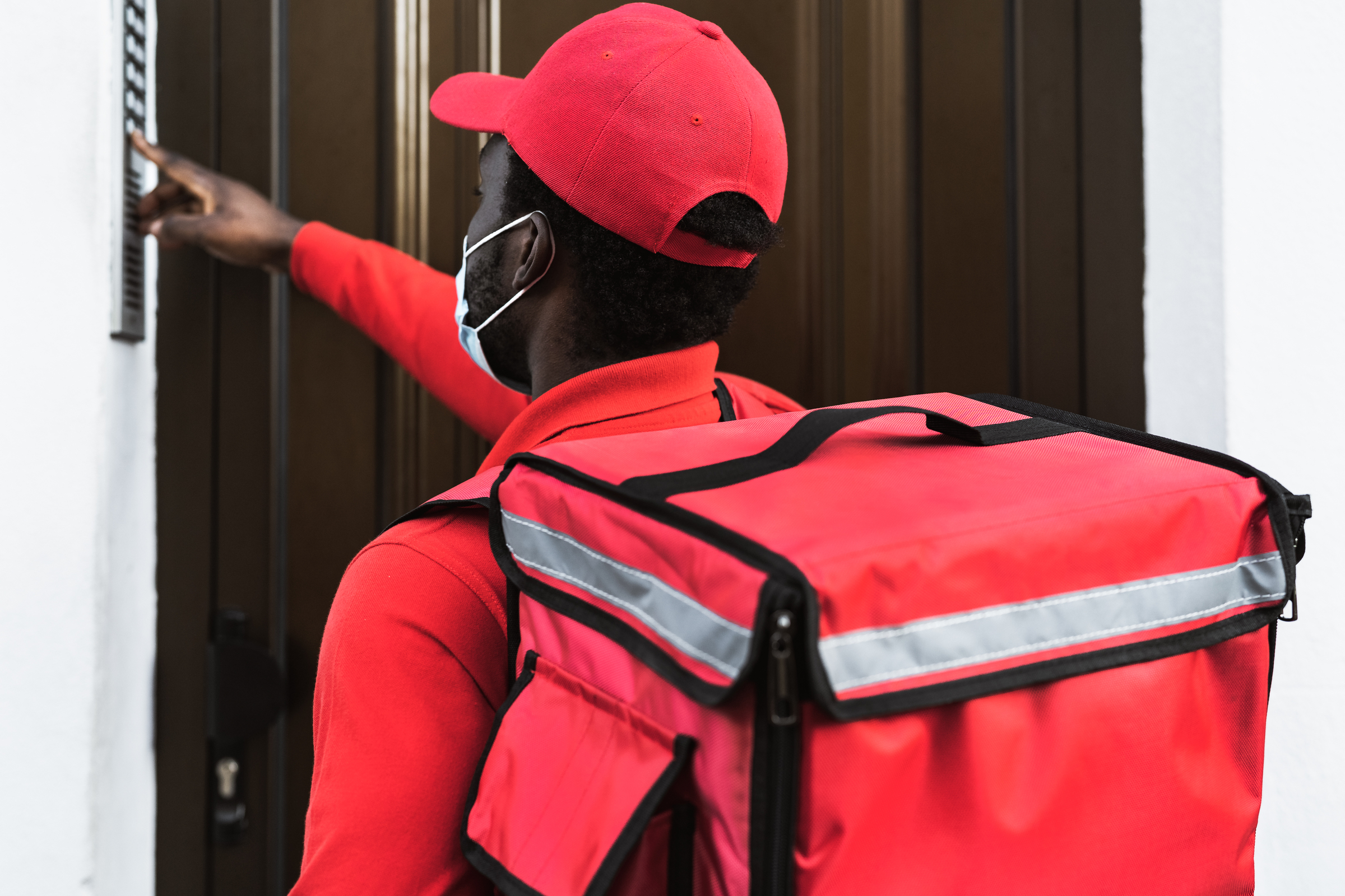 Deliveryman rings buzzer to complete an order, his rights to a higher minimum wage protected by New York Law.
