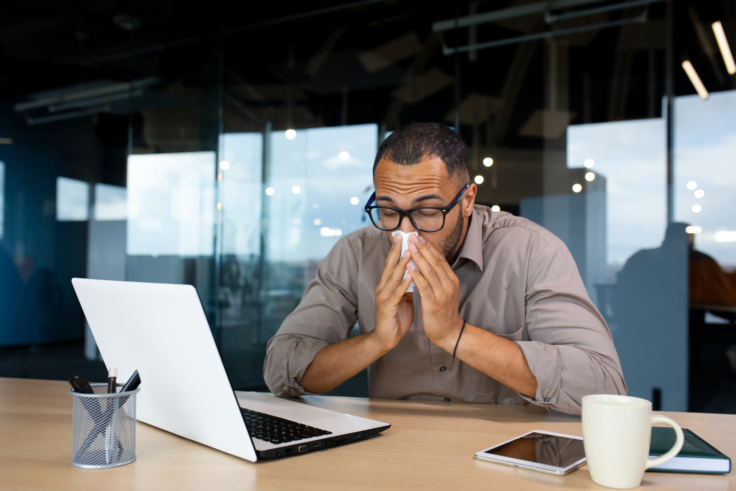 An employee is sick at work, but is too worried to take a day off for fear he'll be fired. An employees' rights attorney can protect his health and job.