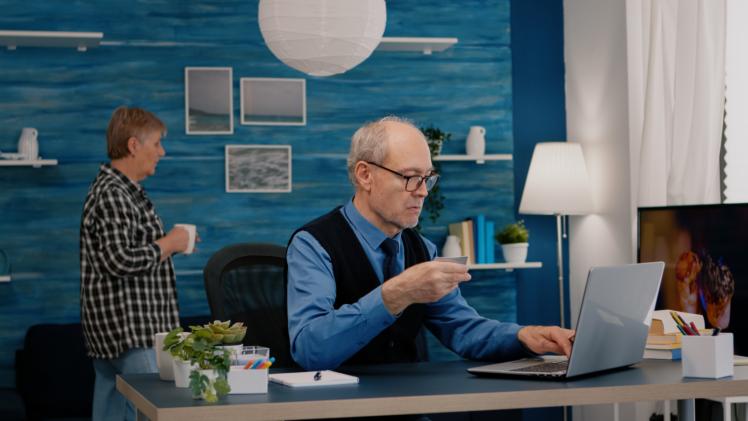 A senior employee completes a sales form for a client after being the victim of age discrimination in a New York office.