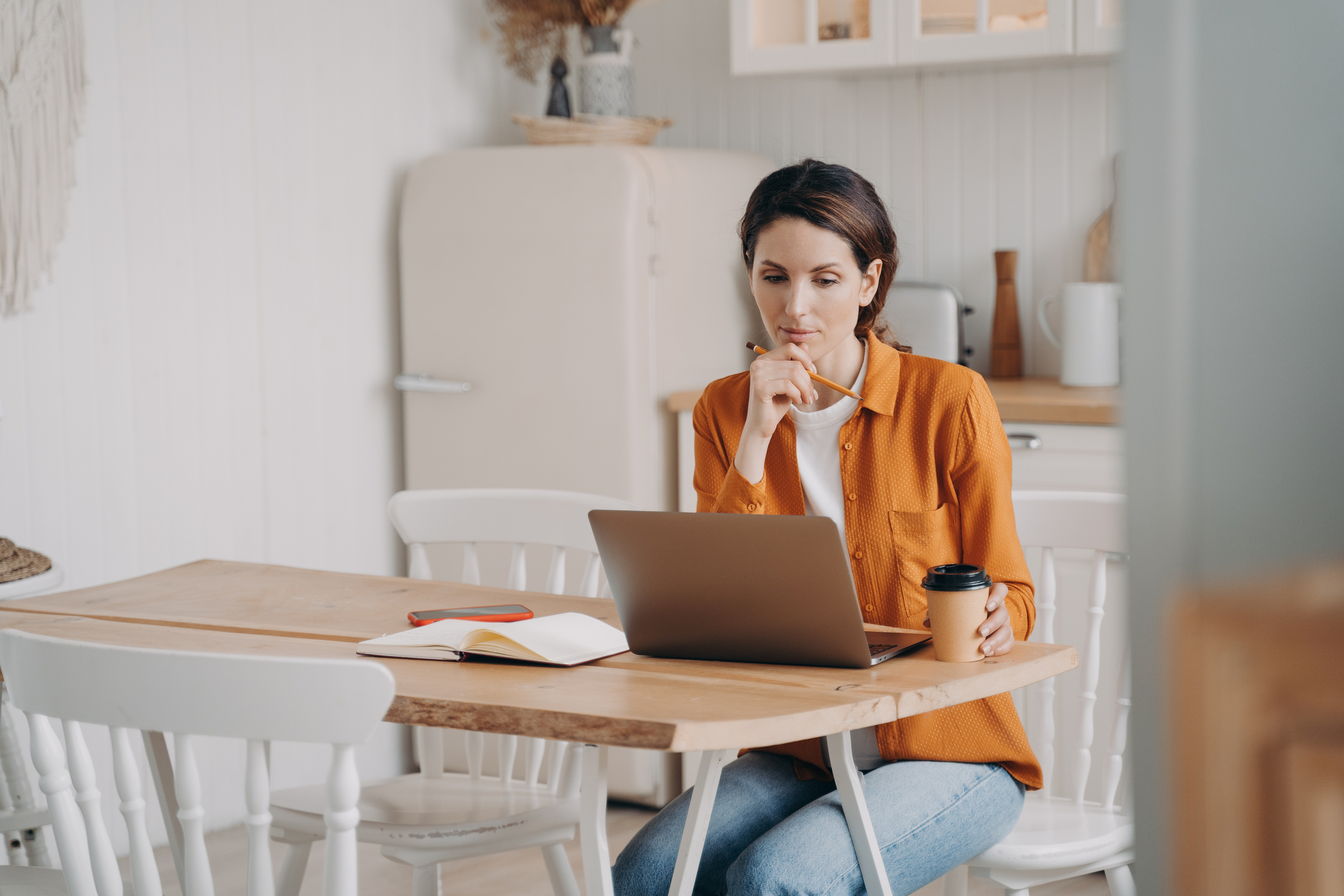 A remote worker checks her contract to see if her role is defined as an independent contractor.