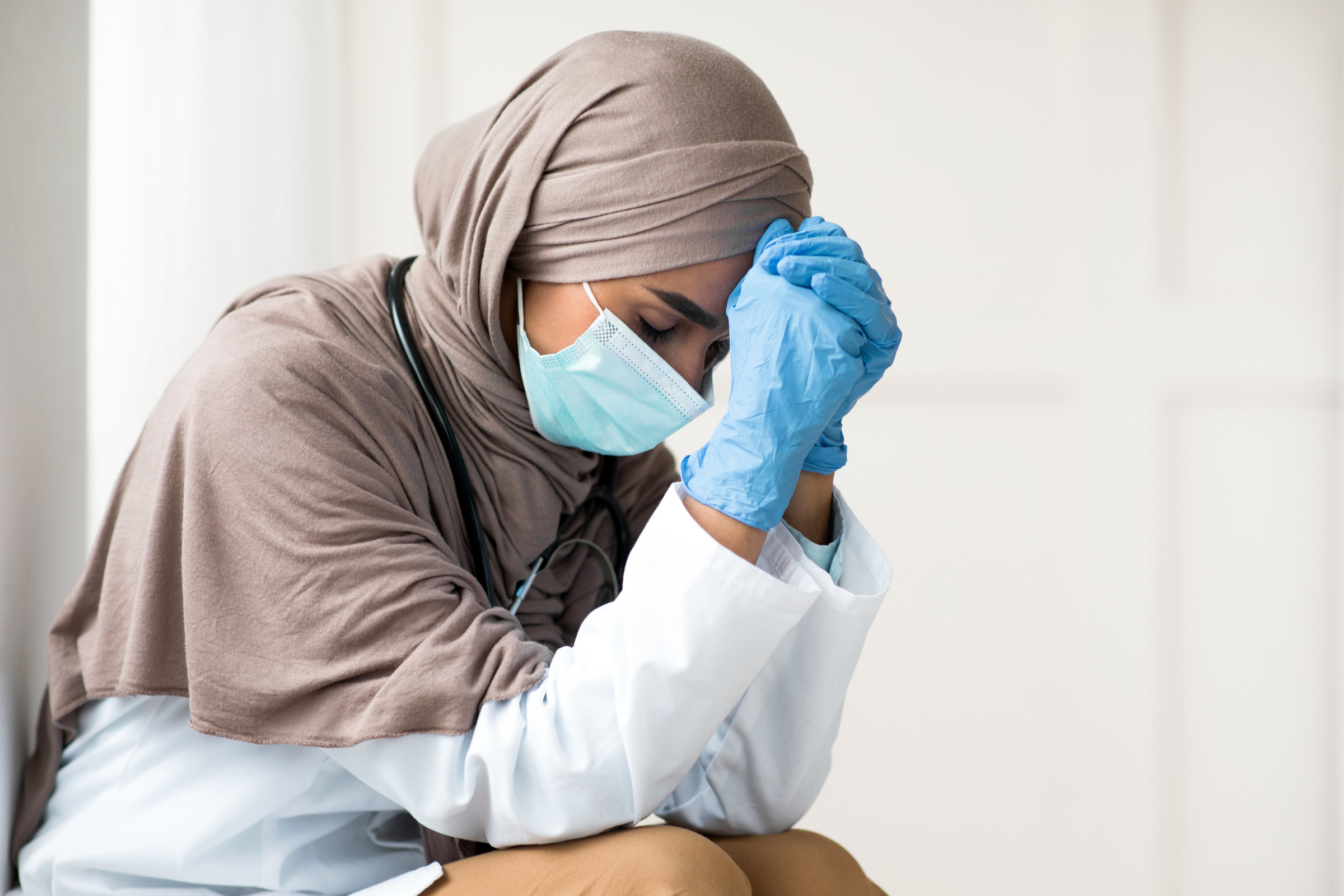 A Muslim doctor takes a moment to collect herself after an incident of religious persecution by a colleague.
