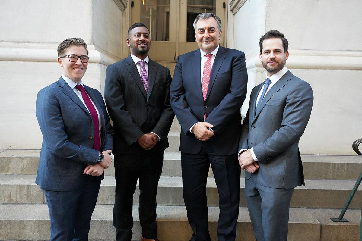 Filippatos partners posing together on courthouse steps