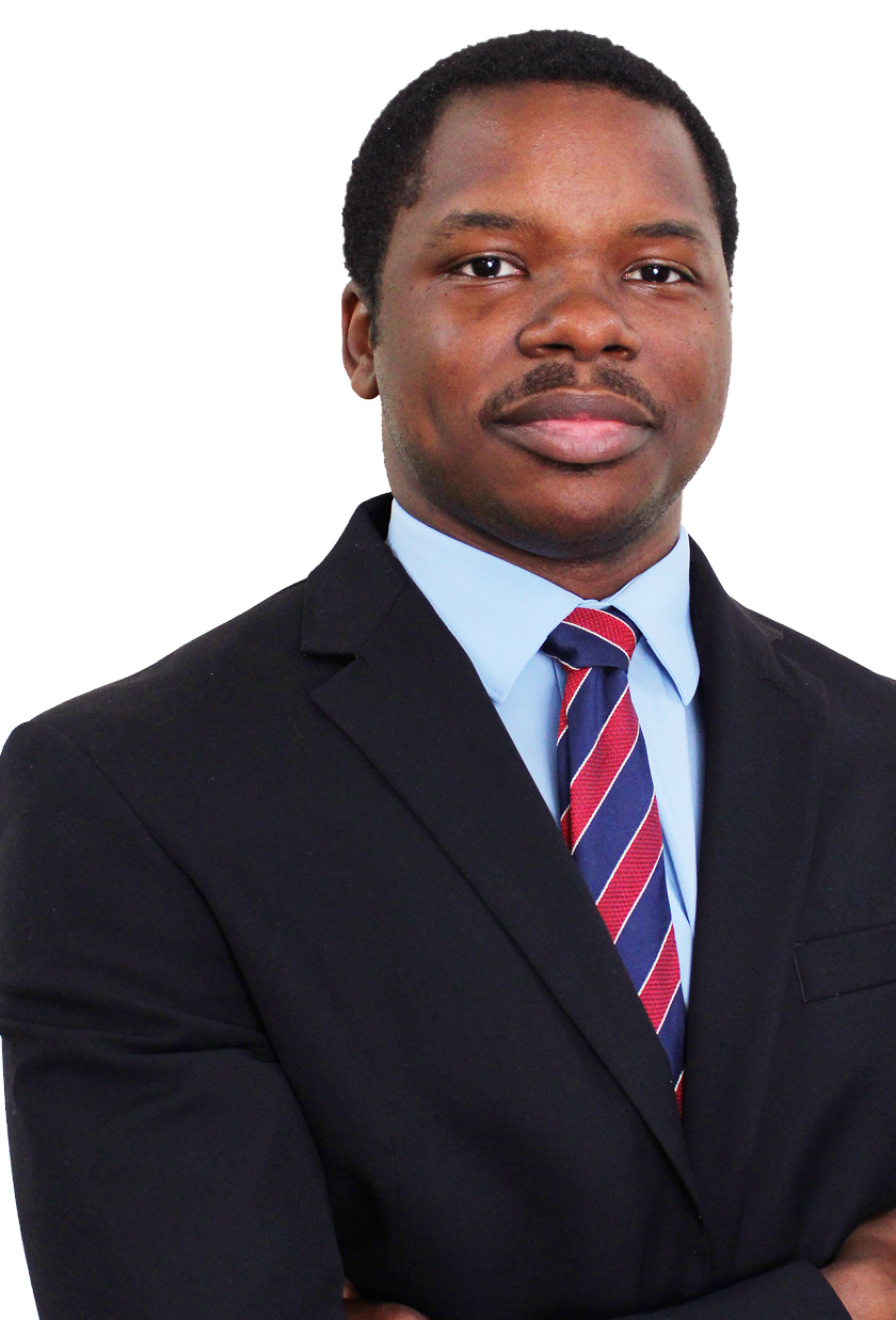 Devin wearing a black suit jacket with a light blue shirt and a red and blue striped tie