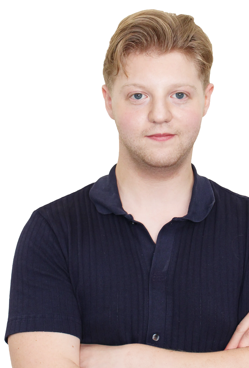 jack standing with crossed arms, wearing a navy blue polo