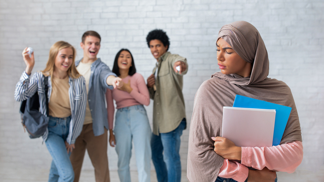A Muslim woman is ridiculed by her coworkers, in a clear case of racial discrimination. As a member of a protected class, she could have grounds to sue.